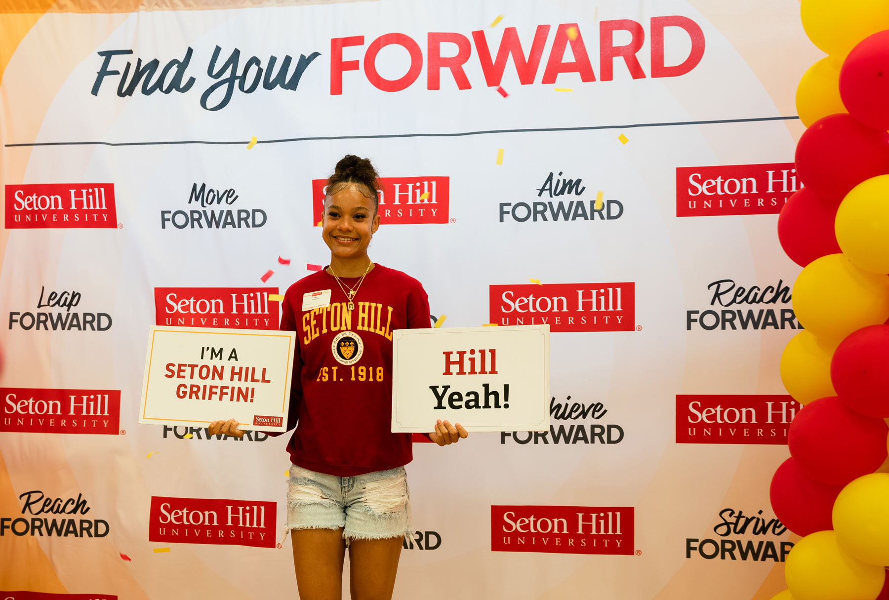 New Student Holding I'm a Seton Hill Griffin Sign