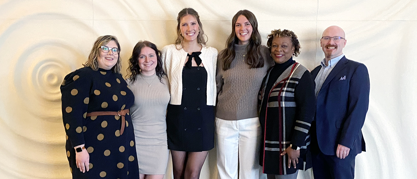 business students and faculty together at a conference