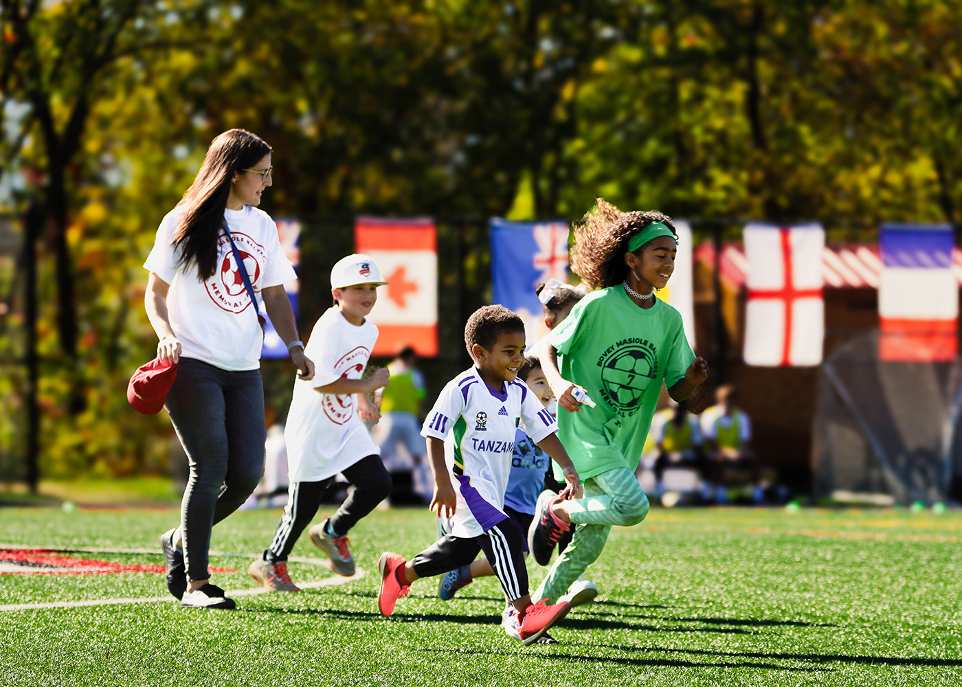 Children run across the soccer field 