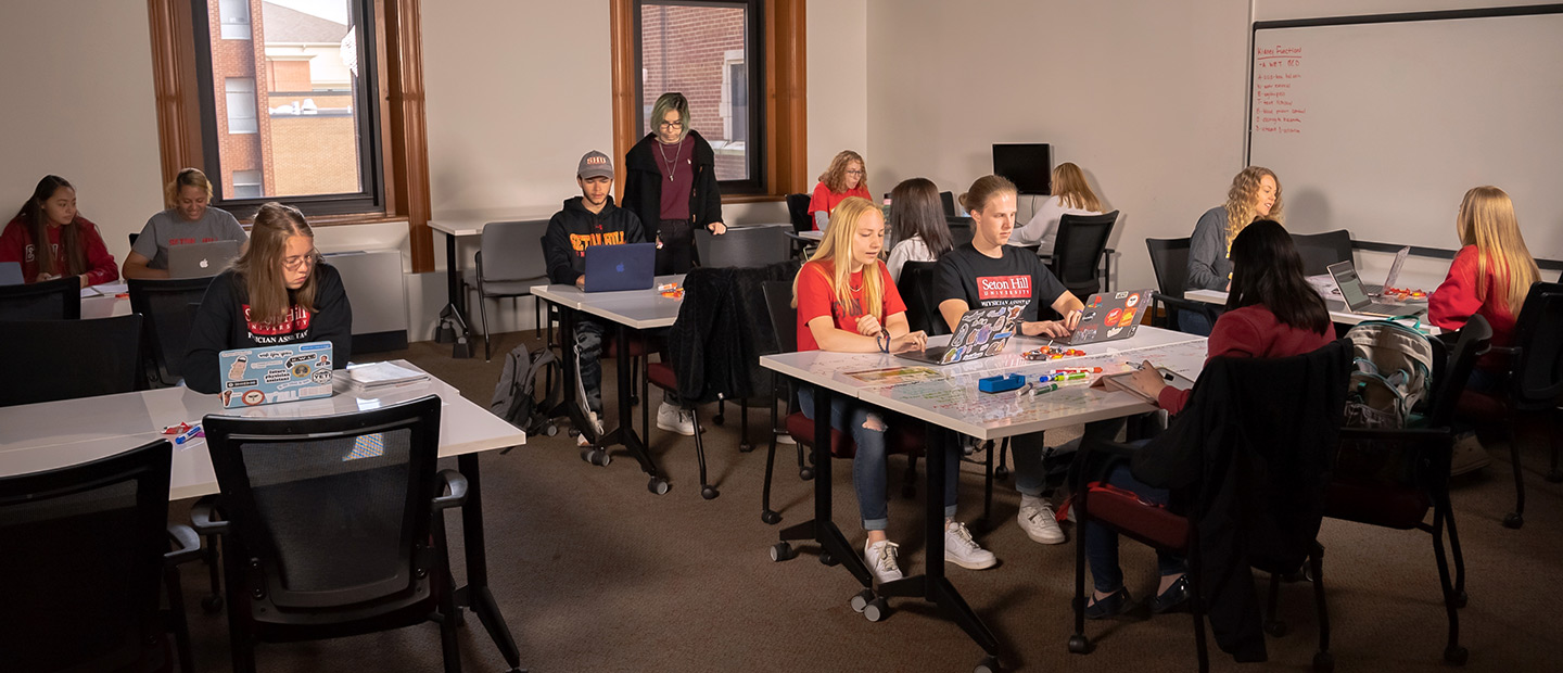 Students sitting and working in the Academic Achievement Center