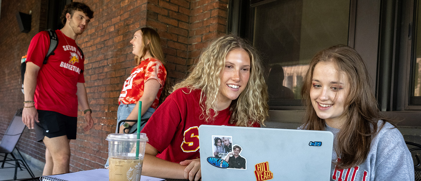 Students studying on Administration Building porch