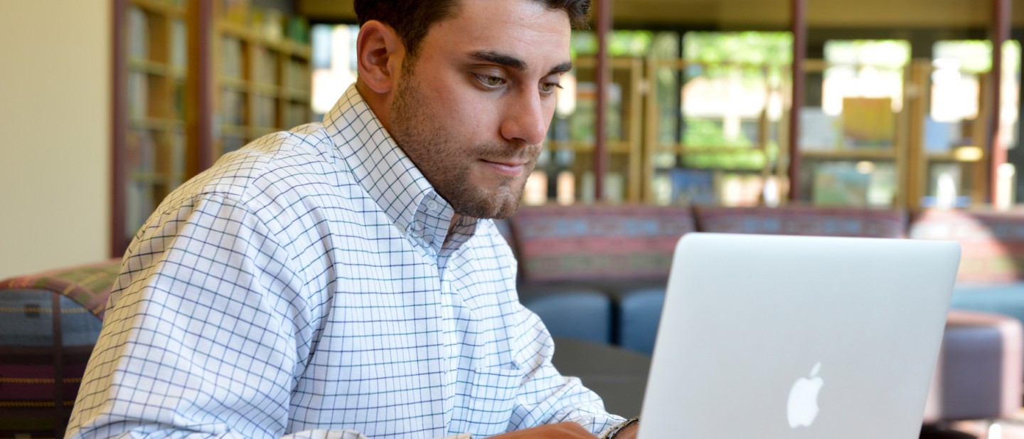 Graduate student looking at MacBook