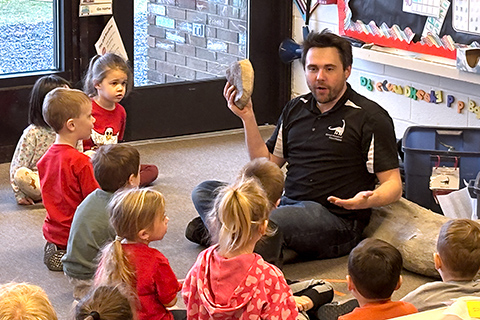 A dinosaur bone presentation to a class of children