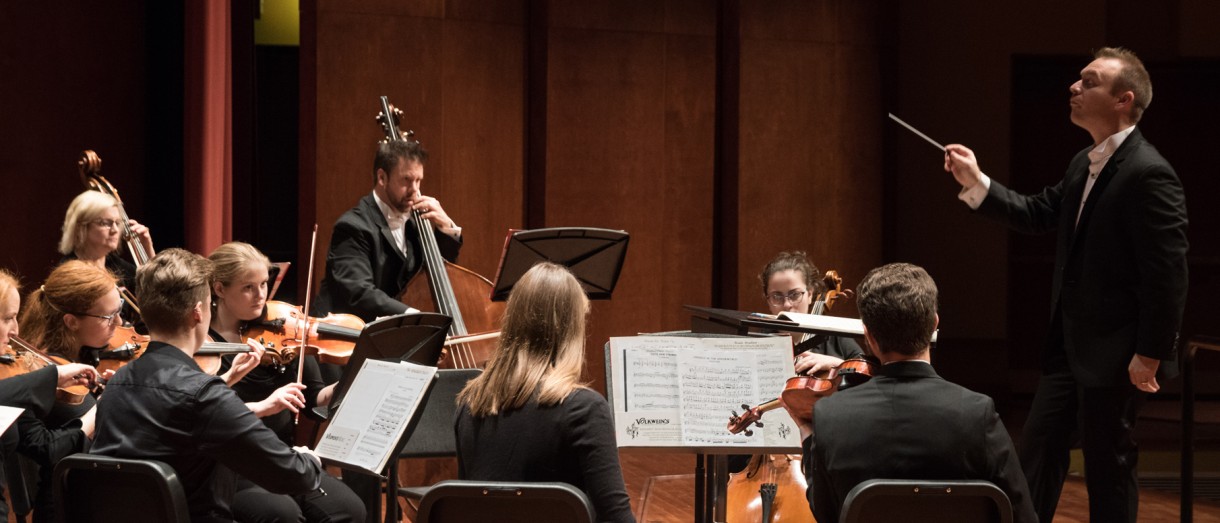 Conductor conducting an orchestra 