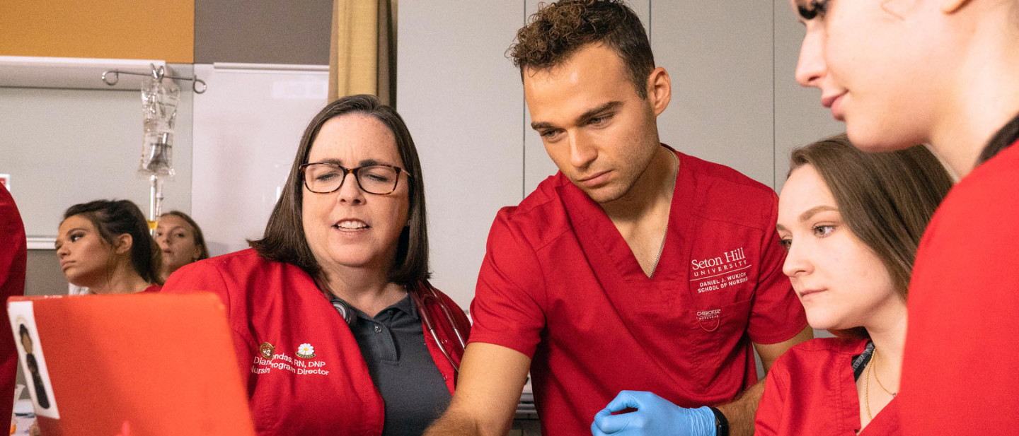 Seton Hill Professor working with Nursing Students in the lab