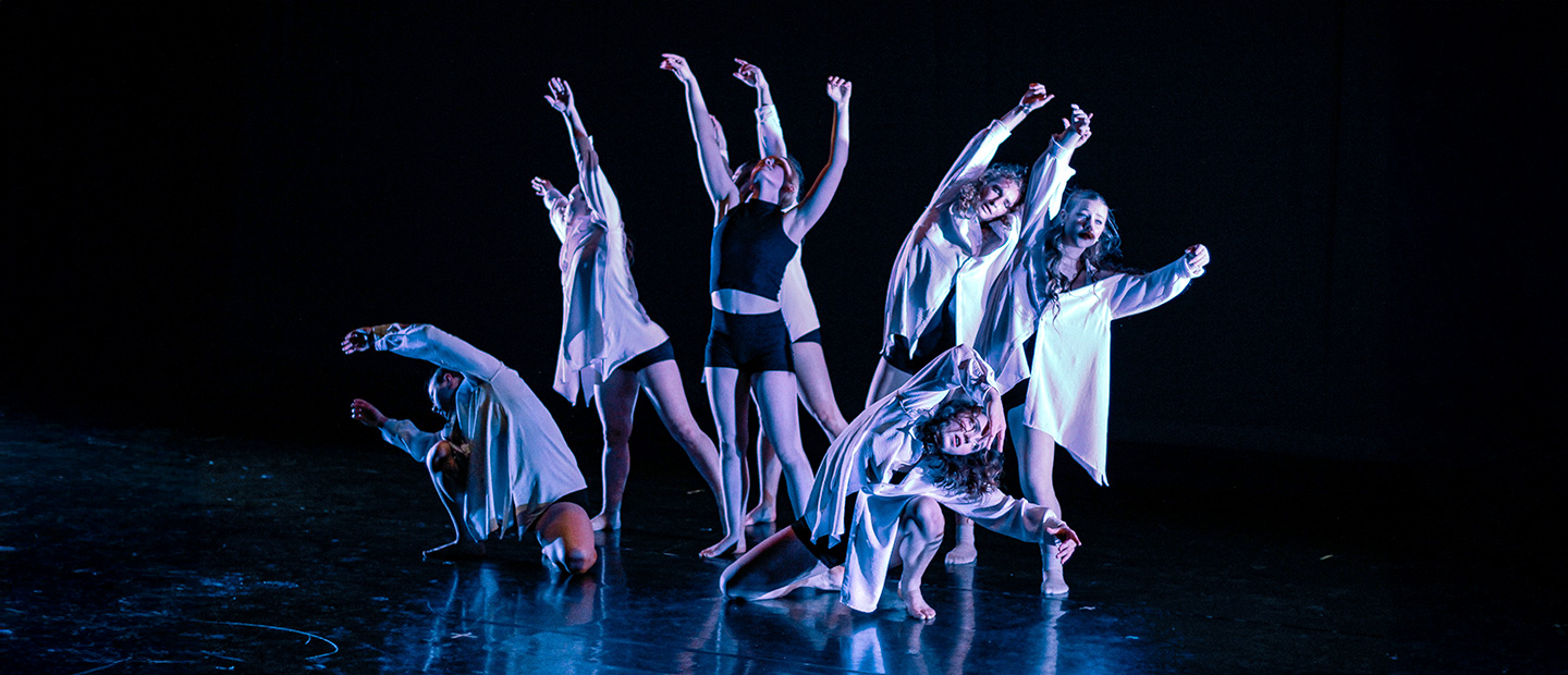 A group of dancers performing on a stage