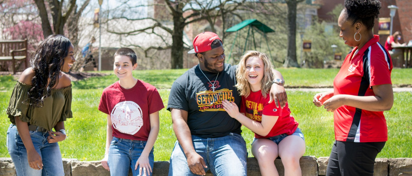 Students sitting on Sullivan Wall