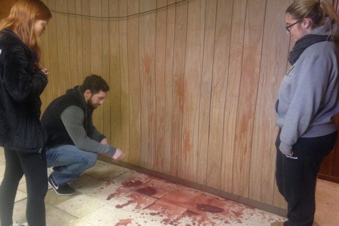 Forensic science students processing visible bloodstain scenes at Seton Hill's crime scene house.