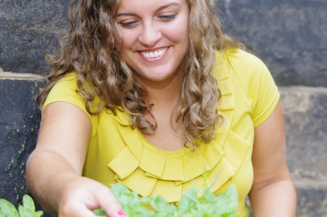 A Seton Hill student checking the progress of the herb garden. 