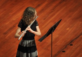 a female Community Music students plays flute in a recital