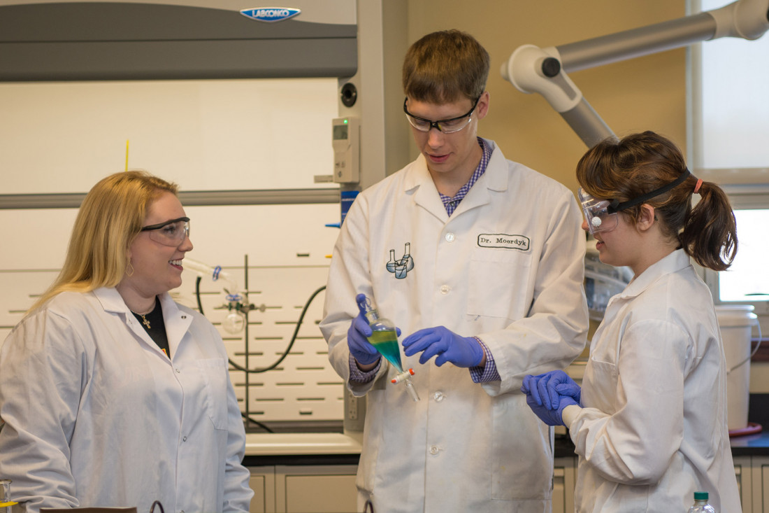 Students work with their professor in a lab in the Boyle Health Sciences Center. 