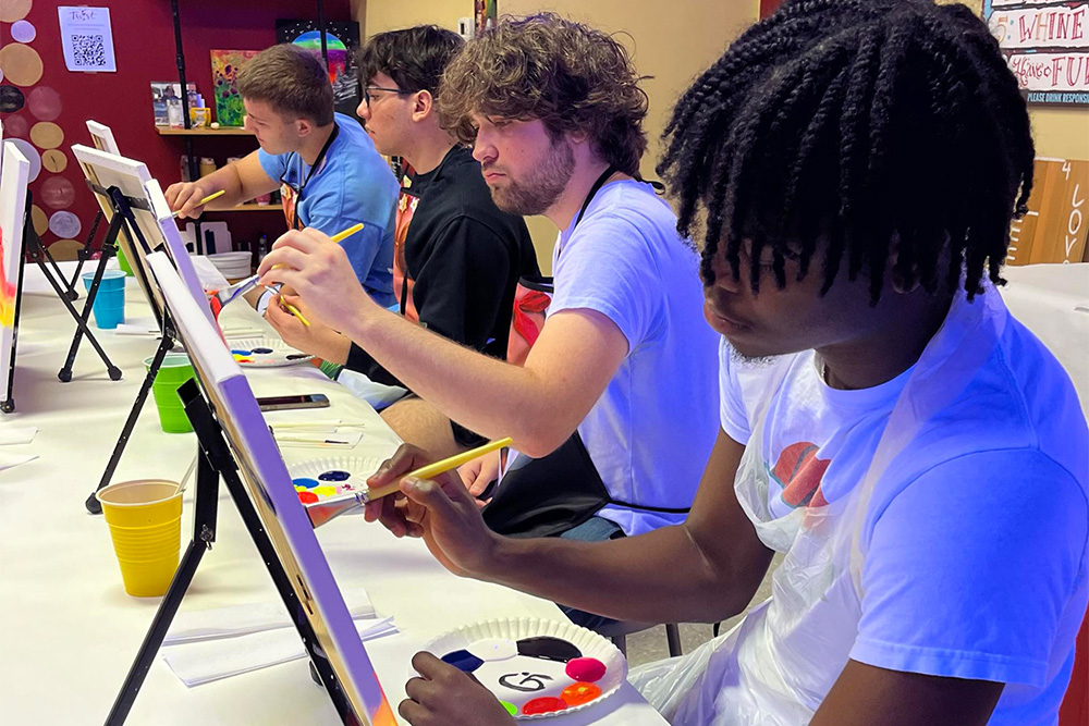 Students create a painting during a Summer Academy event