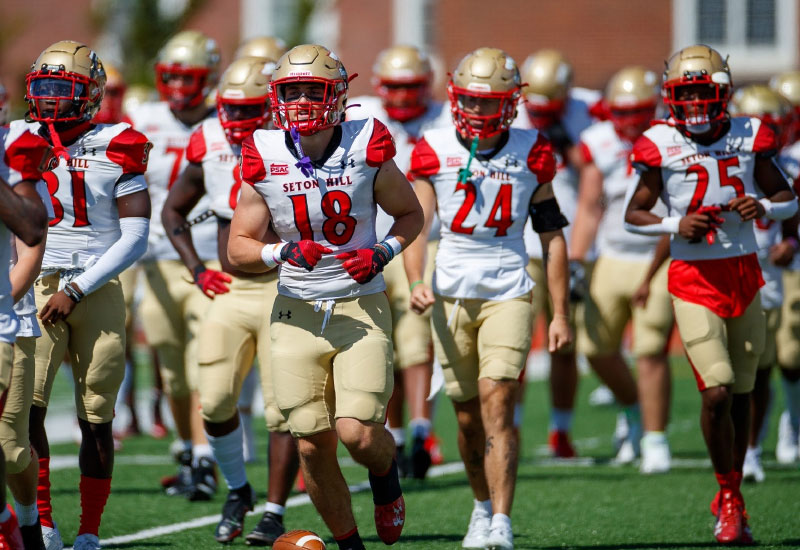 Seton Hill Division II football team running onto the field