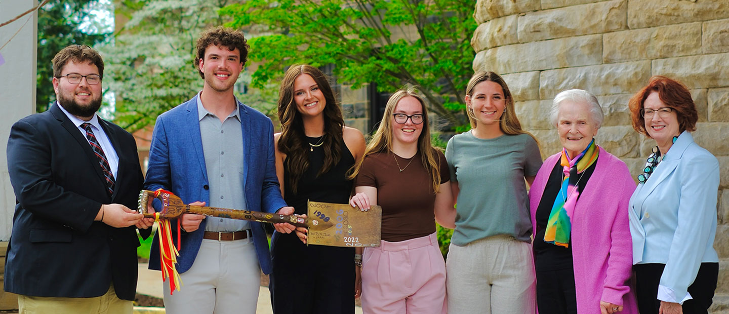 Group of people with a shovel.